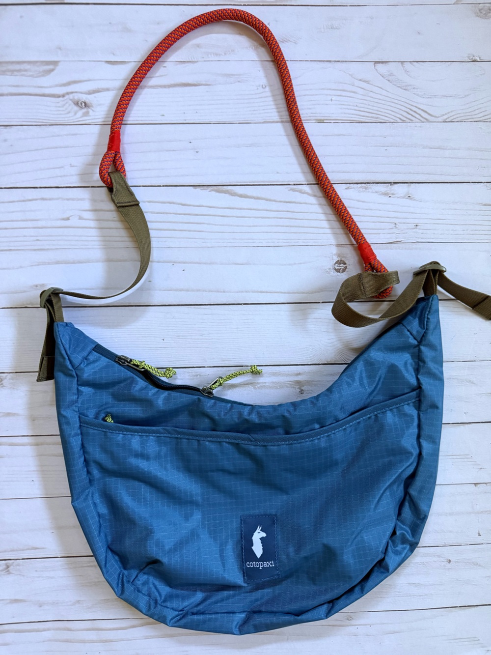 cotopaxi Blue Crossbody Sling Bag with Orange Strap